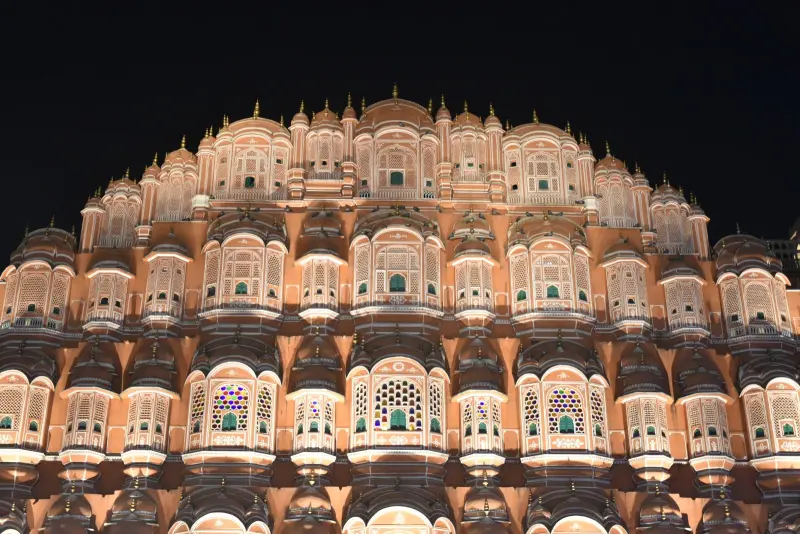 The pink sandstone lattice facade of Hawa Mahal, Jaipur