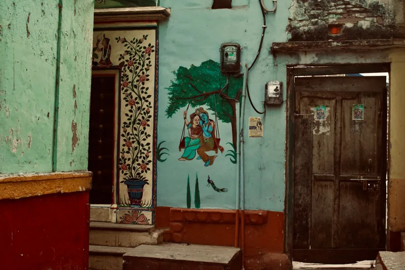 A folk mural painted around a village doorway