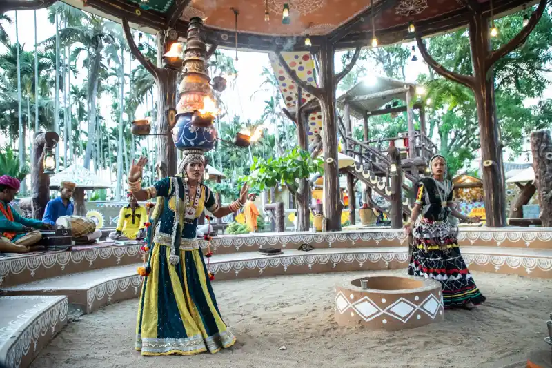 Rajasthani folk dancers in mirrored skirts, balancing pots
